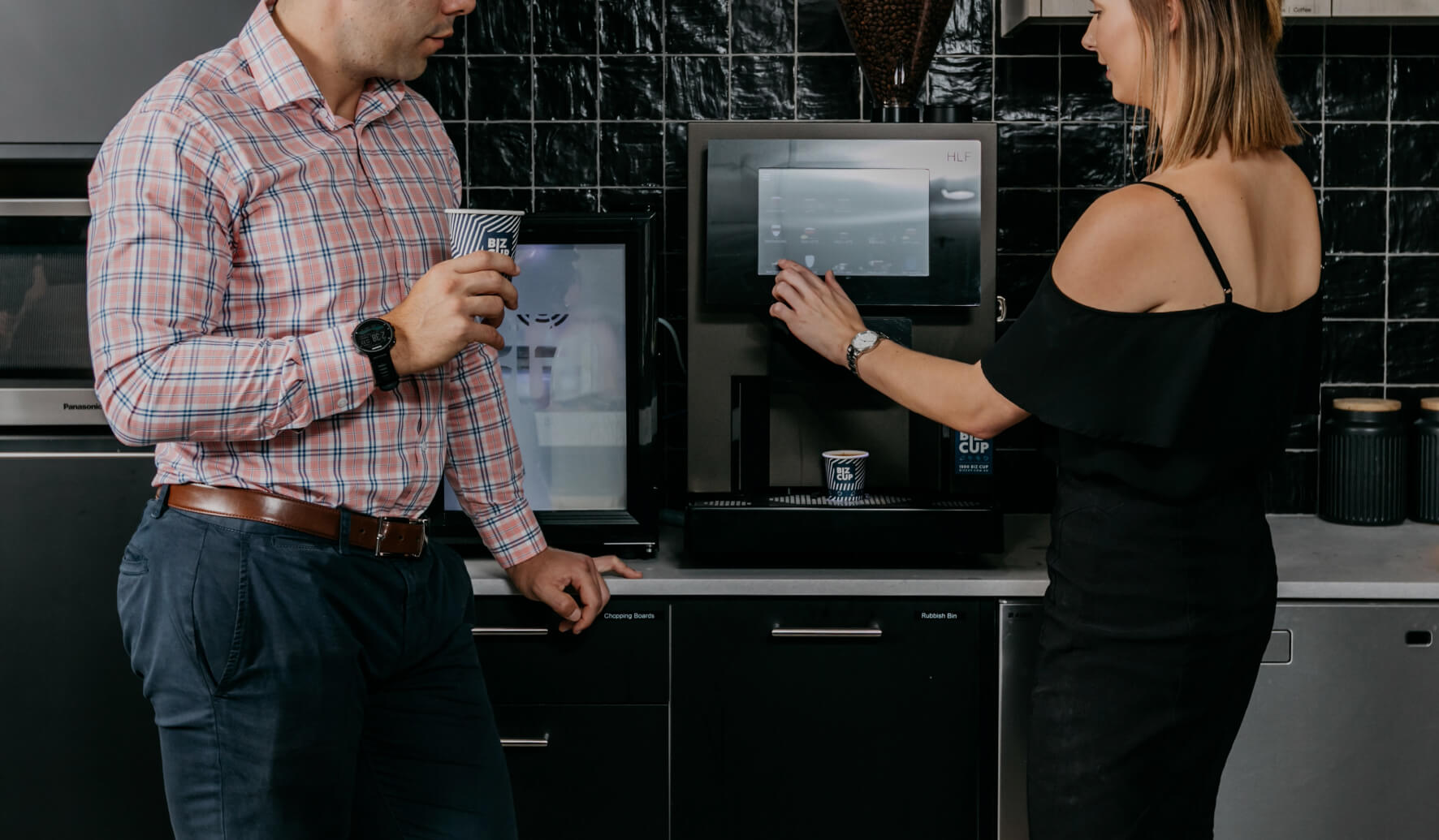 Two staff using an office coffee machine in adelaide