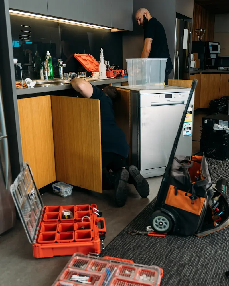 Two men installing an office coffee machine in a workplace in Adelaide